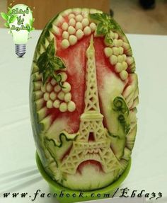 a carved watermelon with the eiffel tower on it's side