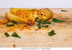 some food that is laying on top of a cutting board with leaves and other things