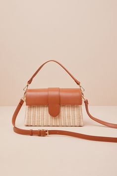 Everyone will be in awe of your elevated aesthetic when they spot you carrying the Moda Luxe Enviable Taste Brown and Ivory Woven Crossbody Bag! This chic bag has a structured woven silhouette with a rectangular design and a flat bottom. Sleek, faux leather top flap has a magentic clasp closure that opens to reveal a roomy interior with a zippered pouch and a sidewall pocket. Style it with the attachable shoulder strap or handbag strap, so you can always match your look! Lined. Bag Measures 10. On-the-go Natural Bag With Detachable Strap, Trendy Shoulder Bag With Detachable Strap In Natural Color, Natural Straw Satchel Bag With Detachable Strap, Natural Satchel Straw Bag With Detachable Strap, Summer Cream Shoulder Bag For On-the-go, Brown Crossbody Baguette Bag With Adjustable Handle, Natural Straw Shoulder Bag With Detachable Strap, Chic Natural Satchel With Removable Pouch, Versatile Beige Straw Bag With Removable Pouch