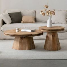 two wooden tables sitting in front of a white couch