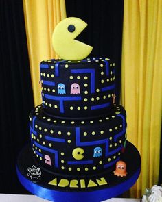 a three tiered cake with pacman decorations on it