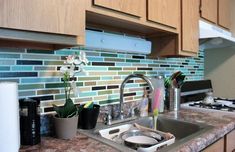 a kitchen counter with a sink and stove top