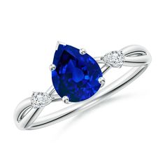 a blue sapphire and diamond ring on a white background