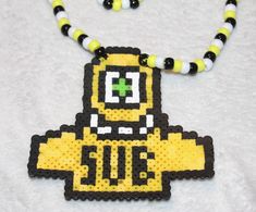 a yellow and black beaded necklace with an image of a cartoon character