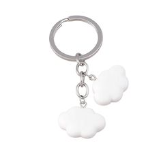 two white clouds are attached to a metal keychain on a white background,