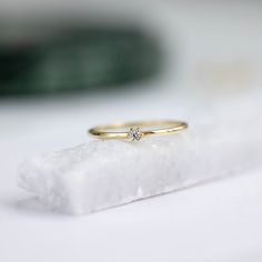 A dainty 14K gold solitaire ring with a tiny diamond 2mm. This stacking diamond ring can be an affordable engagement ring. Its minimalist style makes it perfect for women who love simple elegant jewelry. 100% handcrafted with love!D E T A I L S● Metal: 14K solid gold● Gemstones: Diamond● Diamond's weight: .035ct● Diamond's Cut: BrilliantR I N G ∙ S I Z I N GFor General Reference:● we use standard US Ring Sizing● an average women's ring finger is size 6-7● each ring is custom made upon order, in Minimalist 14k Gold Wedding Ring With Prong Setting, Minimalist 14k Gold Wedding Ring With Brilliant Cut, Minimalist Everyday Diamond Ring With Round Cut, Everyday Minimalist Round Cut Diamond Ring, Everyday Minimalist Diamond Ring, Tiny Delicate Diamond Ring For Anniversary, Delicate Tiny Diamond Ring For Anniversary, Dainty Diamond Midi Rings With Round Cut, Dainty Diamond Ring For Anniversary