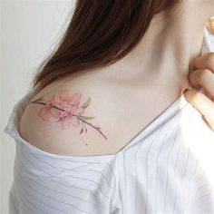 a woman with a flower tattoo on her shoulder