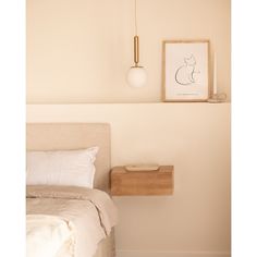 a bedroom with a bed, nightstand and painting on the wall