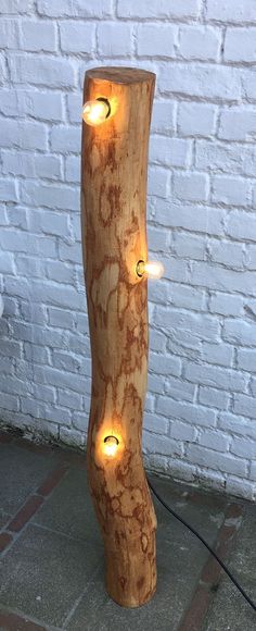 a wooden lamp that has some lights on it