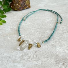 A soft green macrame necklace mixing Clear Quartz and Brass. A great boho feel to it! ✨ - A sliding knot allows for easy length adjustment from choker to 60cm/23.5". - Faceted Clear Quartz double ended point, 3cm by 1cm - 8mm & 6mm faceted Clear Quartz  - Brass charms & beads to finish - Jewellery grade nylon knotting cord Quartz - Clear (Rock Crystal): The most powerful healing stone on earth. Energy amplifier. Develops spirituality and connection to the universe beyond self. Great for clarity. Bohemian Green Crystal Necklace For Beach, Adjustable Bohemian Quartz Necklace, Energy Signature, Crystals Crown, Adjustable Macrame Crystal Necklace With Waxed Cord, Handmade Spiritual Quartz Necklace, Interchangeable Macrame Crystal Necklace, Green Macrame, Macrame Jewellery