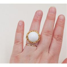 This is part of Chairish’s Costume Jewelry assortment.  1970s Modernist goldtone and white cabochon adjustable ring. Marked "Napier." Measures: 7/8 inches tall by 1 inch wide by 1 3/8 inches deep. Excellent condition. Vintage Gold Dome Ring With Oval Cabochon, Vintage White Oval Cabochon Ring, Gold Cabochon Moonstone Ring Collectible, Vintage White Moonstone Ring In Oval Cabochon, Unique White Oval Cabochon Rings, Oval White Brass Jewelry, Adjustable Gold Moonstone Cabochon Ring, Unique White Cabochon Moonstone Ring, Vintage White Cabochon Jewelry