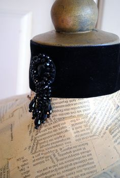 This elegant wide black velvet choker is quite striking in its simplicity. It is hand-beaded with black crystals at the center front, placed in a tear-drop shape along with five black crystals strands that cascade gracefully to adorn the neck. This choker closes at the back of the neck with black satin ribbon, so it comes in One Size. This item is sent packaged securely and sent out with DHL Express, delivered in 2-6 days depending on your location. Please, add your phone number at the Message t Gothic Black Choker For Evening, Black Gothic Choker For Evening Wear, Handmade Black Victorian Choker, Vintage Black Choker For Evening, Victorian Goth Jewelry, Wedding Victorian, Different Ear Piercings, Crystal Ball Necklace, Types Of Ear Piercings