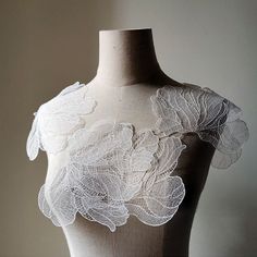 a mannequin with white lace on it