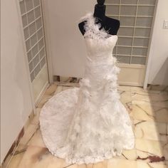 a white wedding dress on display in a room