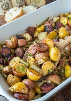 a casserole dish with potatoes and green beans in it on a wooden table