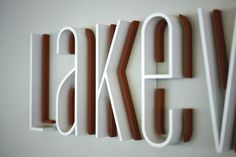 the letters are made out of white and brown wood