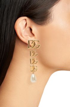 Bring Dolce&Gabbana's signature glamour to any look with these clip-on earrings flaunting goldtone logos and lustrous baroque imitation pearls. Clip-on style Nickel-free Hypoallergenic Goldtone plate/acrylic imitation pearl Made in Italy Luxury Metal Drop Clip-on Earrings, Luxury Clip-on Metal Earrings, Elegant Gold Jewelry With Logo Charm, Luxury Gold-tone Clip-on Jewelry, Luxury Metal Clip-on Earrings For Evening, Luxury Gold Clip-on Earrings With Logo, Elegant Gold-tone Jewelry With Logo Charm, Elegant Dangle Jewelry With Logo Charm, Luxury Metal Clip-on Jewelry