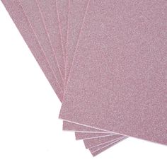 six pink glitter paper sheets stacked on top of each other