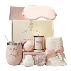 a pink gift box containing a sleeping mask, eye mask and other items