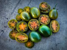 some green and yellow tomatoes on the ground