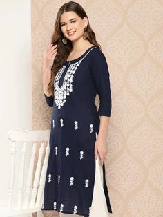 A charming navy blue and white cotton kurta, meticulously adorned with floral embroidered Chikankari detailing. The straight shape enhances its elegant silhouette, making it a perfect blend of traditional craftsmanship and contemporary style. Single Piece Fabric: Cotton Color: Navy Blue & White Neck: Round Neck Sleeve: 3/4th Sleeves Style - Straight Shape with Regular Style Work Done: Floral Embroidery with Chikankari Detailing Length - Calf Length Washing Instructions: Hand Wash Size & Fit - Mo Kurta Style, Kurta Design, Navy Blue Fabric, Cotton Kurta, Blue Solid, Kurta Designs, Womens Size Chart, Top Fabric, Navy Women