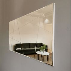 a mirror reflecting a couch and table in a room