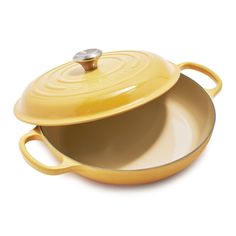 a yellow casserole dish with an oval lid and handles on a white background