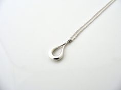 Overview:Offered
 for sale is a wonderful Tiffany classic.   Whether you are just 
starting your Tiffany collection or are thinking of adding another 
piece, this one is perfect for you.  Tiffany & Co.'s Sterling Silver Open Teardrop necklace is a Tiffany classic that will never go 
out of style. It will most certainly be a piece that you will turn to 
over and over again, so it is great value for your money!  It is a 
wonderful necklace that fits a lifestyle on the go -- the necklace can Classic Drop Earrings With Polished Finish For Gift, Classic Drop White Gold Necklace, Modern Teardrop Necklace For Anniversary, Formal Drop Necklace With Polished Finish, Classic Silver Teardrop Drop Necklace, Classic Teardrop Drop Necklace Gift, Modern Teardrop Drop Necklace For Formal Occasions, Classic Silver Drop Necklace, Timeless Silver Drop Necklace Gift