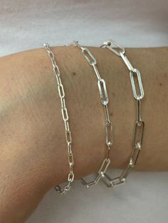 "Super trendy and stylish handmade sterling silver paperclip bracelets 2.5mm, 3mm & 4mm Solid 925 sterling silver Stamped \"925\" & \"Italy\" We have in 6-8\" Here is weights for 7\"...if your bracelet is longer or shorter weight will vary slightly 2.5mm- 2g 3mm- 2.7g 4mm- 4.8g Ships fast We also sell matching chains Let us know if any questions" Silver Sterling Paperclip Chain Bracelet, Handmade Paperclip Jewelry For Everyday, Silver Sterling Minimalist Paperclip Bracelet, Silver Minimalist Sterling Silver Paperclip Bracelet, Dainty Silver Adjustable Paperclip Bracelet, Classic Handmade Chain Bracelet For Everyday, Silver Paperclip Bracelet With Cable Chain For Everyday, Sterling Silver Bracelet With Oval Link Paperclip Chain, Dainty Sterling Silver Paperclip Bracelet