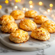 several biscuits on a marble plate with candles in the background