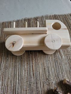 a wooden toy train sitting on top of a rug