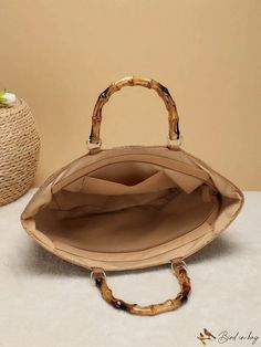 BirdinBag - Striped Bamboo Straw Bag: Spacious, Stylish, Double-Handled, Zippered - Perfect for Vacations! Beige Top Handle Bag With Bamboo, Beige Top Handle Bag With Bamboo Detail, Beige Top Handle Bag With Bamboo Handle, Brown Handheld Canvas Bag, Everyday Bamboo Handle Bucket Bag, Brown Satchel Bag With Bamboo Handle, Beach Bag With Bamboo Handles For Shopping, Beach Bag With Bamboo Double Handles For Shopping, Everyday Bucket Bag With Double Bamboo Handle