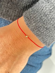 This red string bracelet is made from waterproof silk string and solid 14K gold, sterling silver, or  24K gold vermeil  3 mm bead. Wish bracelet is a beautiful way to give someone you care for a wish. All they have to do is make a wish and then tie the cord around their wrist. When the cord finally wears down and breaks the wish is released and will come true - so they say! Details:  * 14K solid gold, sterling silver or 24K gold vermeil bead - 3 mm; * Waterproof Silk String * Adjustable clasp st Minimalist 14k Gold Red Bracelets, Minimalist Red 14k Gold Bracelets, Minimalist Red 14k Gold Bracelet, How To Make Red, Red String Bracelet, Red String, Red Bracelets, Tiny Diamond, Gold Work