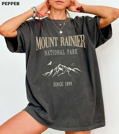 This Mount Rainier National Park comfort colors shirt is super soft and cozy. Perfect to lounge around, run errands, or walk your dog. ABOUT THIS SHIRT   ∙ Shirt is UNISEX and runs slightly large for ladies (For a relaxed fit, I suggest your usual size. For an oversized fit, I suggest sizing up 1 to 2 sizes.) ∙ 100% ring spun medium-weight cotton (soft-washed and garment-dyed) ∙ Colors may vary based on your monitor/screen display or lighting CARE INSTRUCTIONS ∙ Machine wash inside out in cold w Spring Outdoor T-shirt With Letter Print, Casual Gray T-shirt For Outdoor, Spring Outdoor Crew Neck Top, Crew Neck Top For Outdoor Spring Activities, Sporty Tops With Letter Print For Outdoor, Casual Fall Hiking Tops, Spring Crew Neck Top For Outdoor, Casual Tops For Fall Hiking, Fall Hiking T-shirt With Graphic Print