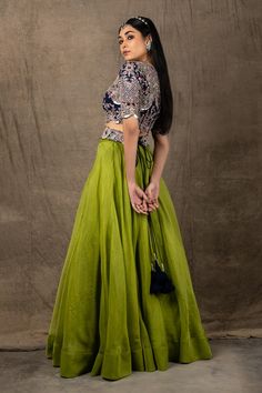 Pista green lehenga in organza. Comes with blue embroidered blouse.
Component: 2
Pattern: Embroidery
Type Of Work: Zardozi, Coin, Mirror and Sequin
Neckline: Round
Sleeve Type: Half
Fabric: Organza and Crepe
Color: Green,Blue
Other Details: 
Cutwork detail on the hems
Closure: Back zip
Note: Belt worn by the model is not for sale
Occasion: Sangeet - Aza Fashions Green Tissue Silk Choli With Intricate Embroidery, Green Organza Lehenga For Reception, Green Organza Choli With Intricate Embroidery, Green Tissue Silk Choli For Festive Occasions, Festive Green Tissue Silk Choli, Green Anarkali Choli In Tissue Silk, Green Tissue Silk Lehenga For Reception, Green Organza Anarkali Set With Cutdana, Green Organza Lehenga With Cutdana