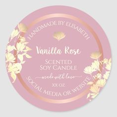 a pink and gold floral label with the words vanilla rose scented soy candle on it