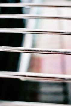 a close up view of metal bars in front of a building with a blurry background