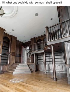 an empty room with stairs and bookshelves on the walls is featured in this post