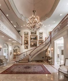 a large foyer with chandelier and stairs leading up to the second floor area