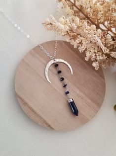 This unique pendant necklace will complete any outfit for day or night. The moon is a symbol of change and regeneration. Lapis Lazuli, the stone of wisdom. Helps us to reconnect with our inner self. Lapis is used to form stronger bonds of friendship and generate inner peace and honesty. A hammed crescent Moon is accented with tiny Lapis Lazuli stones that are wire wrapped together and joined to a Lapis Spike stone. This unique pendant is suspended from shimmering Sterling Silver chain in your ch Bohemian Moon Phase Necklace In Sterling Silver, Bohemian Sterling Silver Moon Phase Necklace, Adjustable Moon Shape Necklace With Moon Charm, Adjustable Moon Phase Necklace, Celestial Style Necklace With Moon Charm, Spiritual Sterling Silver Moon Phase Necklace, Celestial Crescent Jewelry For Meditation, Sterling Silver Necklaces With Moon Charm For Meditation, Bohemian Sterling Silver Moon Charm Necklace