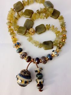 Georgian green beach glass is just one element in this special necklace with its handmade lampworked mossy olive green pendant beads with gold accents and gold magnetic clasp.  Just the perfect accessory for your day at the local vineyard.  Necklace length - 28 inches  Pendant - 68mm x 40mm Please don't hesitate to contact me should you have any questions or concerns.  Thank You for visiting Mt Nebo Designs and I look forward to you stopping by again soon Handmade Gold Jade Beaded Necklaces, Green Beaded Jewelry In Recycled Glass, Green Beaded Jewelry With Recycled Glass, Green Beaded Jewelry From Recycled Glass, Green Beaded Necklaces With Recycled Glass For Gifts, Green Recycled Glass Beaded Necklaces For Gifts, Green Recycled Glass Beaded Necklace As Gift, Green Recycled Glass Beaded Necklace Gift, Green Natural Stones Jewelry In Recycled Glass