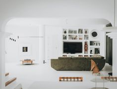 a living room filled with furniture and a flat screen tv