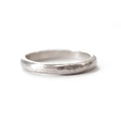 Hammered by hand in our Vermont jewelry studio, this band delivers everything that is timeless and classic about a simple hammered wedding band--in stunning white gold. Band and Width: A half-round 2mm, or 5mm wide band. For a more delicate look, choose the dainty 2mm band or go for a bolder option with the 5mm.Metal: Shown here in 14k white gold with a hammered finish.Sourcing note: We use 100% ethical, recycled, metals refined in the USA. Any of our designs can also be made in hypoallergenic, White Gold Hammered Promise Ring, White Gold Hammered Ring Jewelry, Simple Gold Wedding Band, Hammered Platinum Wedding Band, 14k Gold Hammered Wedding Rings, Hammered White Gold Wedding Band, Hammered Wedding Bands, 14k Gold Wedding Ring, Hammered Band