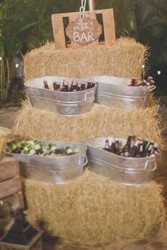 an assortment of desserts in buckets sitting on top of a hay bale