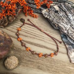 "I was drawn to these sparkly topaz beads, which reminded me of tiger lilies. The orange variants of these flowers really stand out to me during the summer. I also recently discovered \"prairie tiger lilies\" - the newest wildflower I'll be trying to find on hikes! This color scheme will be perfect to follow stacks into autumn and matches perfectly with the classic beaded version, found here: https://colorsoftheprairie.etsy.com/listing/1513762563  This listing is for 1 adjustable seed bead brace Brown Flower-shaped Beaded Jewelry, Orange Bohemian Jewelry For Friendship, Adjustable Hand-strung Flower Jewelry, Orange Round Beads Friendship Bracelets As Gift, Orange Festival Bracelet, Orange Flower Jewelry For Beach, Orange Flower-shaped Jewelry For Beach, Orange Flower-shaped Beach Jewelry, Orange Beaded Flower-shaped Jewelry