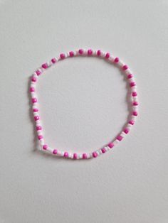 Silicone wire bracelet with rounded plastic colored beads. They can be made any size, arrangement, color and message. Due to the silicon wire, they are elastic and can be easily passed over your fist. The beads are rounded and about 1mm in diameter. White Plastic Beaded Bracelets, White Plastic Bracelets With Letter Beads, White Plastic Beaded Bracelets For Friendship, Plastic Bracelets With Letter Beads, Pink Plastic Stretch Bracelet With Letter Beads, Pink Stretch Bracelet With Spacer Beads For Friendship, Bracelets Pink, Beaded Braclets, Beads Craft