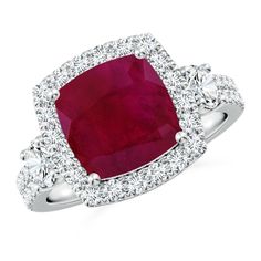 a ruby and diamond ring with white diamonds around the band, set in 18k white gold