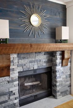 a fire place in a living room next to a wall with a mirror on it