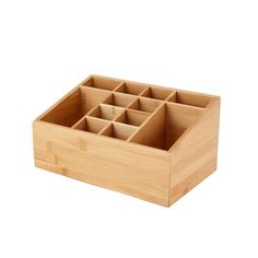 a wooden box filled with compartments on top of a white background