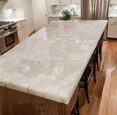 a large kitchen island with marble counter tops